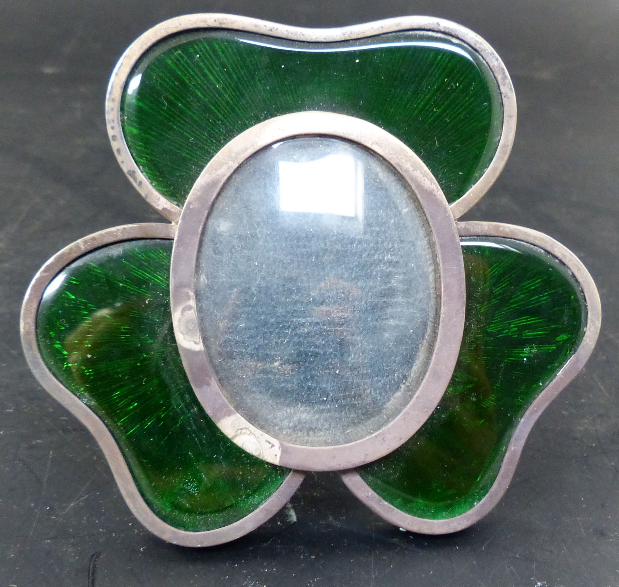 A late Victorian silver and green enamel mounted shamrock photograph frame, 97mm.